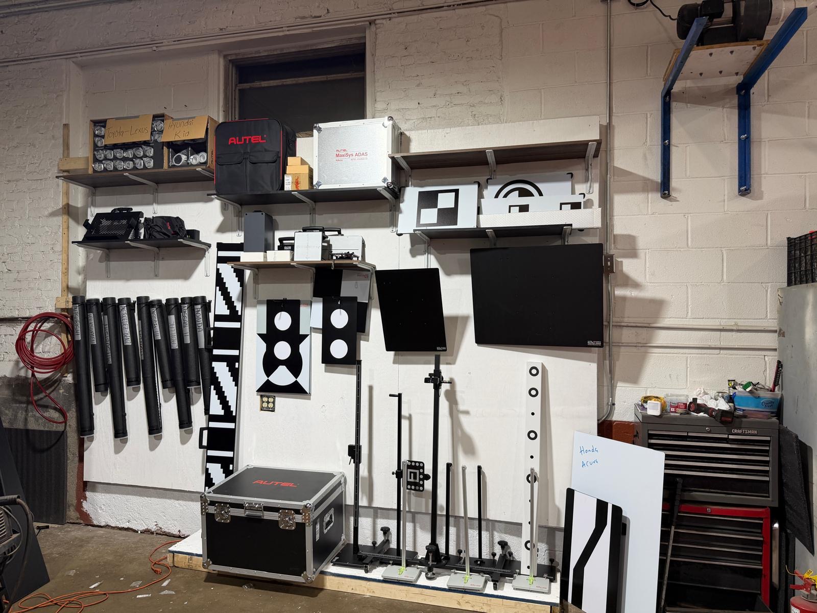 ASI targets system showing precision calibration setup with various manufacturer-specific patterns and target boards ready for ADAS calibration procedure